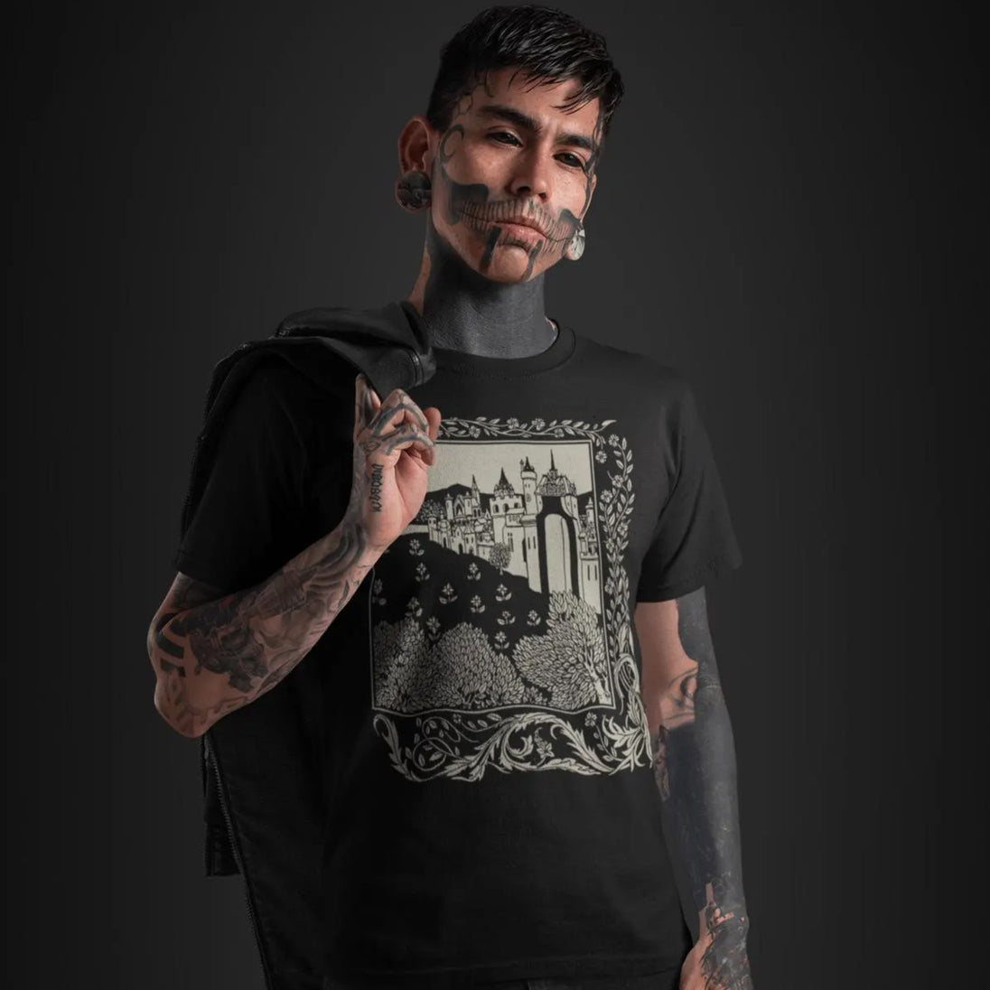 Man wearing a black Medieval Castle T-Shirt on a dark background
