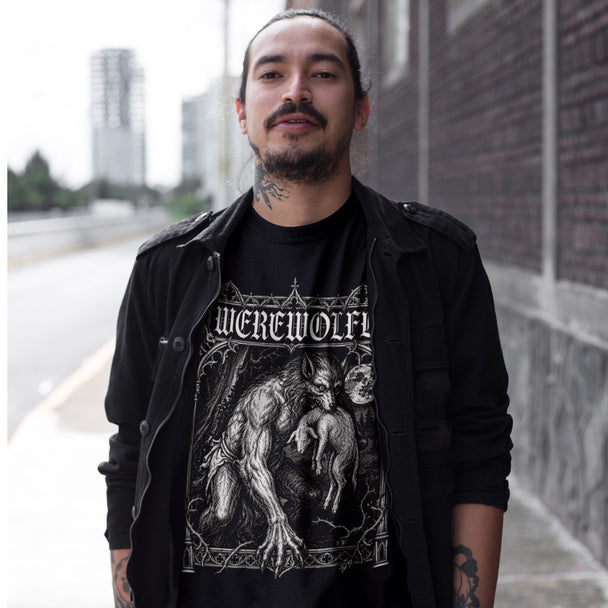 Man wearing a black t-shirt with 'Werewolf' design outdoors.