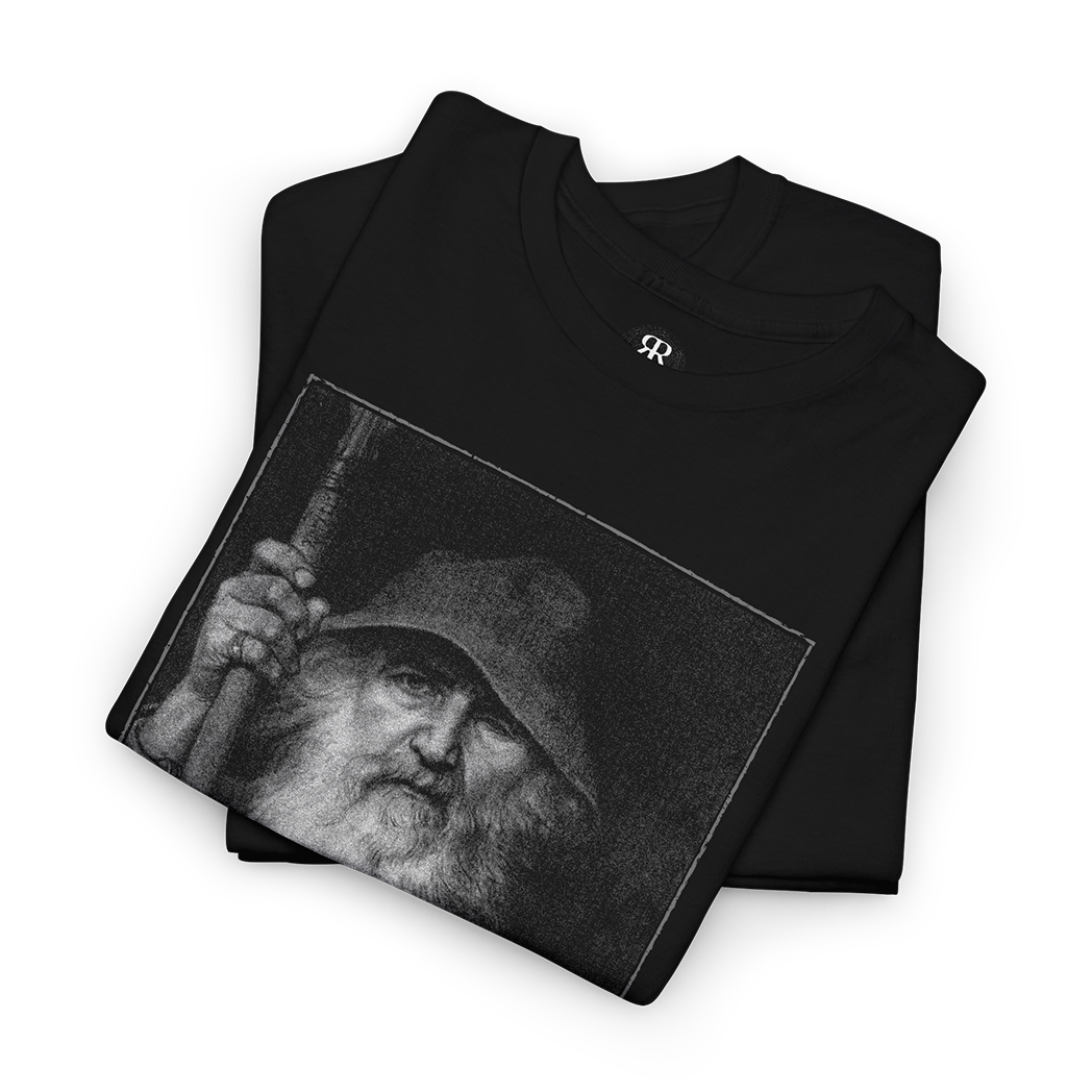 Black T-shirt featuring a monochrome graphic of Odin, the All-Father from Norse mythology, with a staff, and Elder Futhark script below.