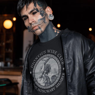 Person wearing a black leather jacket with a Dionysus Wine Club t-shirt in a dimly lit setting.