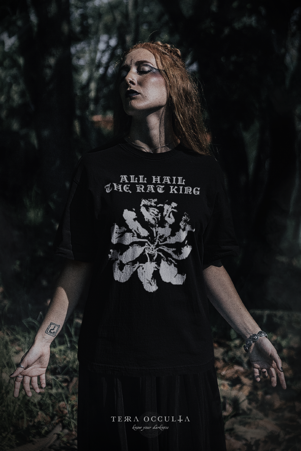Alternative woman wearing black t-shirt with a graphic saying ALL HAIL THE RAT KING