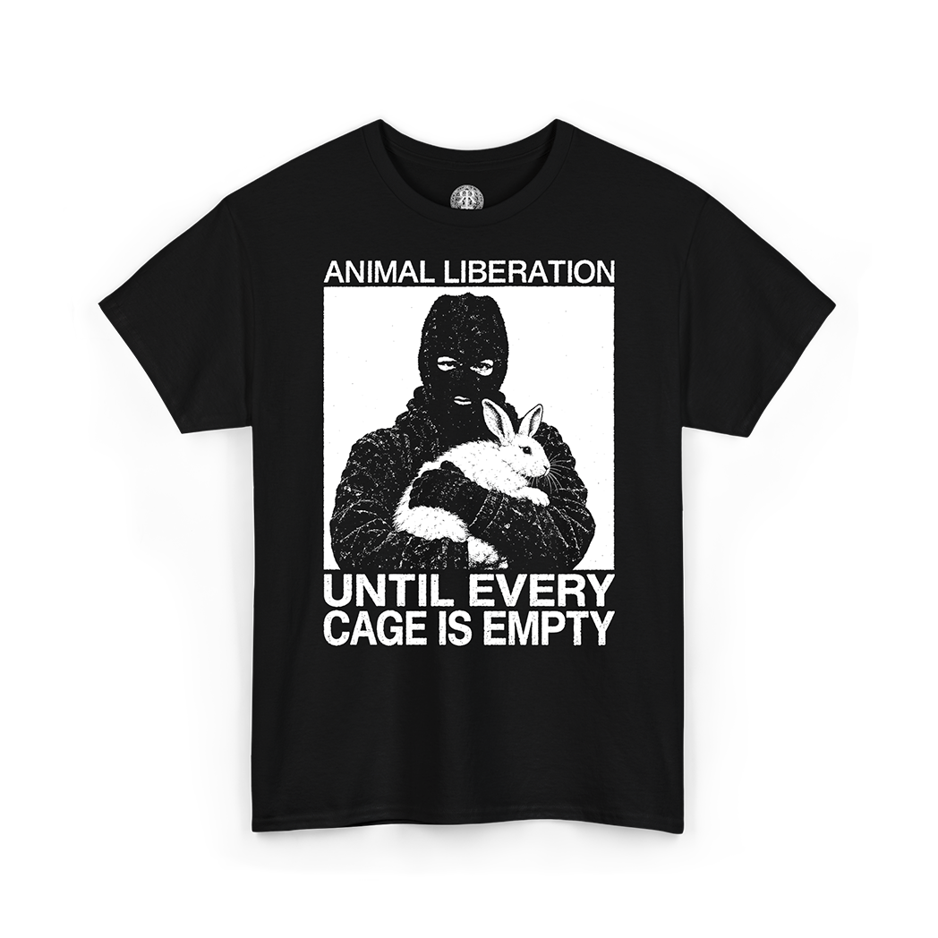 A black short-sleeve crewneck t-shirt featuring a white graphic print of a person in a balaclava holding a rabbit, with the text 'ANIMAL LIBERATION' above and 'UNTIL EVERY CAGE IS EMPTY' below.