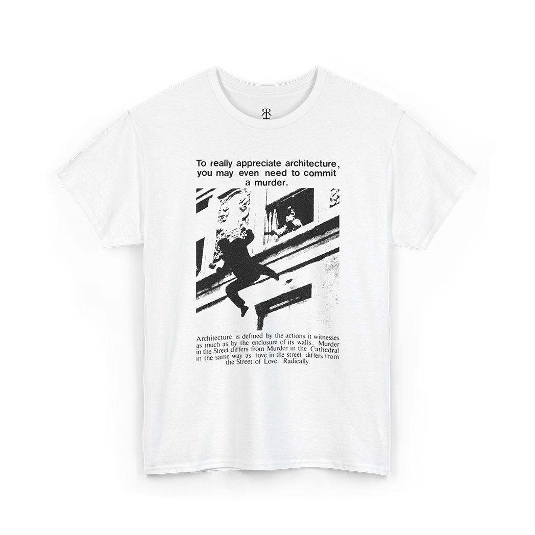 A white short-sleeve crewneck t-shirt with a black graphic print on the front. The graphic features a black-and-white photograph of a figure climbing a building next to a quote about architecture and murder, with a small stylized logo printed inside the collar.
