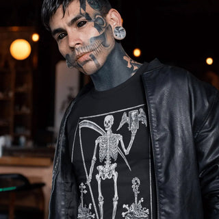 Person wearing a black leather jacket and a black t-shirt with a skeleton design, standing in a dimly lit room.
