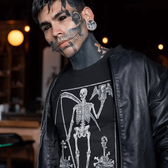 Person wearing a black leather jacket and a black t-shirt with a skeleton design, standing in a dimly lit room.