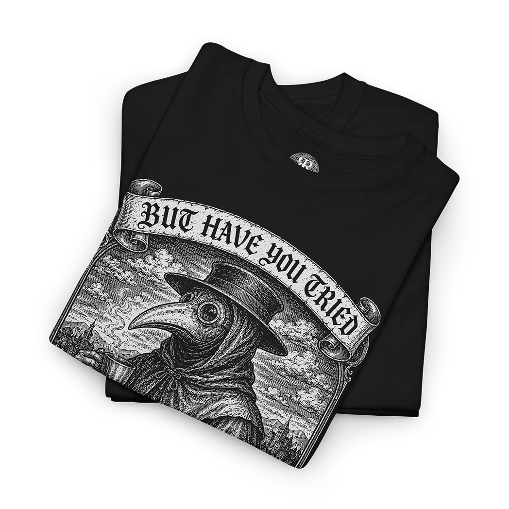 A folded black t-shirt featuring a detailed black and white graphic of a plague doctor with a banner that reads 'BUT HAVE YOU TRIED LEECHES'.