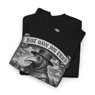 A folded black t-shirt featuring a detailed black and white graphic of a plague doctor with a banner that reads 'BUT HAVE YOU TRIED LEECHES'.