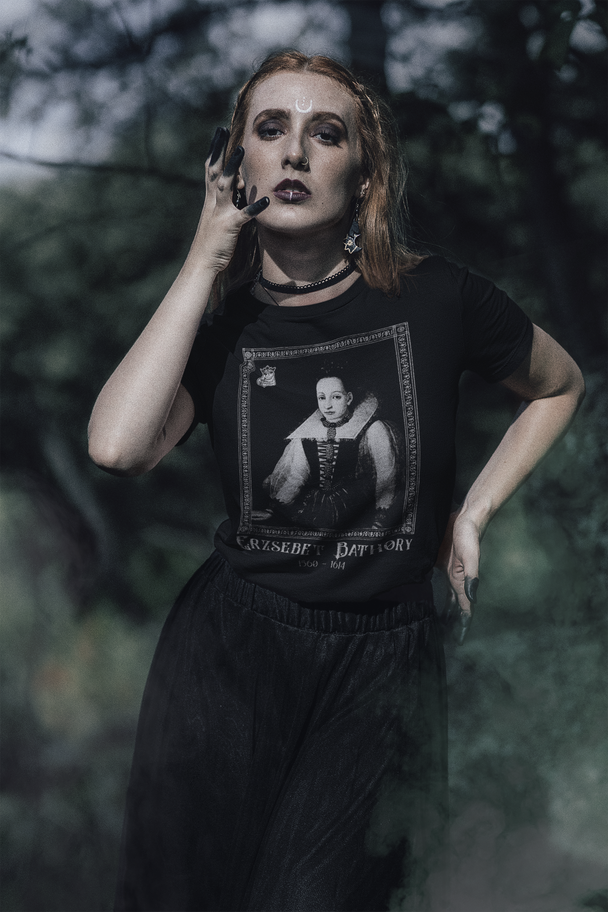Woman wearing shirt showing framed portrait of Elisabeth Bathory