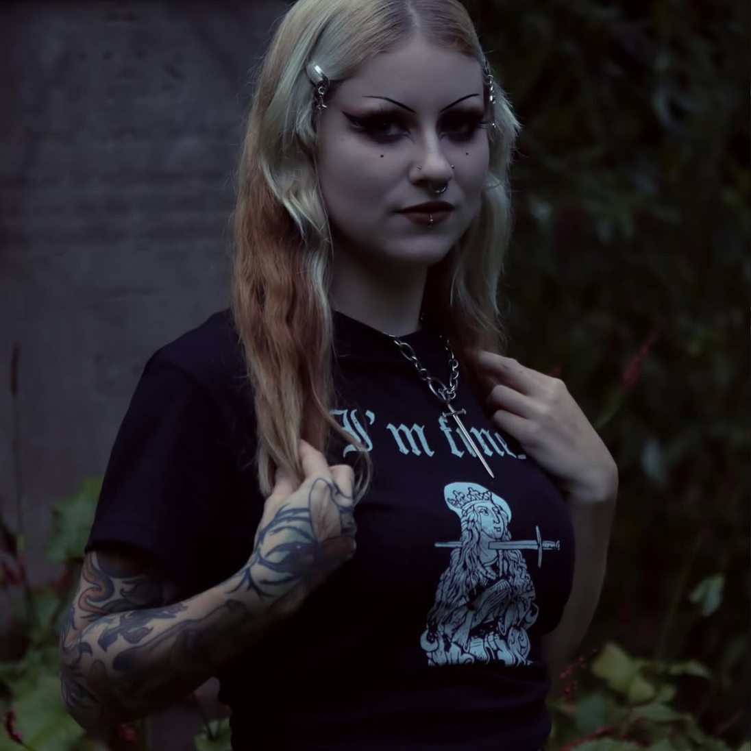 Woman wearing a black t-shirt with 'I'm fine' statement and medieval woodcut of st.lucy