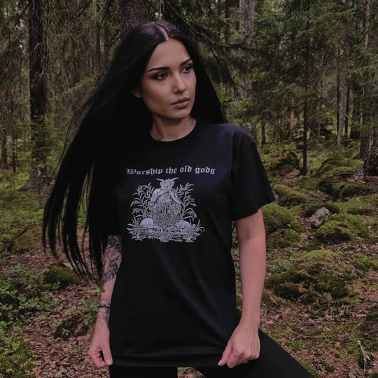 Woman wearing black Worship the Old Gods T-Shirt in a forest setting