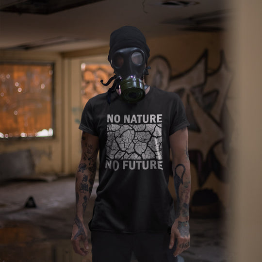 Person wearing a gas mask and a t-shirt with 'No Nature No Future' text in a dark, graffiti-covered room.