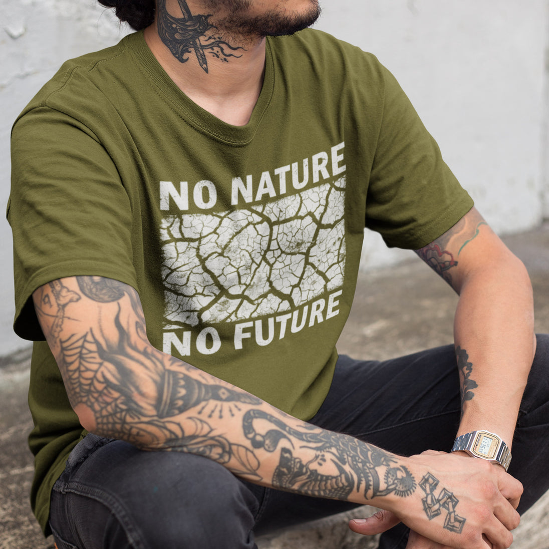 Person wearing a olive green t-shirt with 'No Nature No Future' text and graphic design.