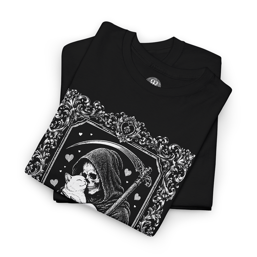A black folded t-shirt with a detailed black and white graphic of a grim reaper holding a cat, set against a plain white background.
