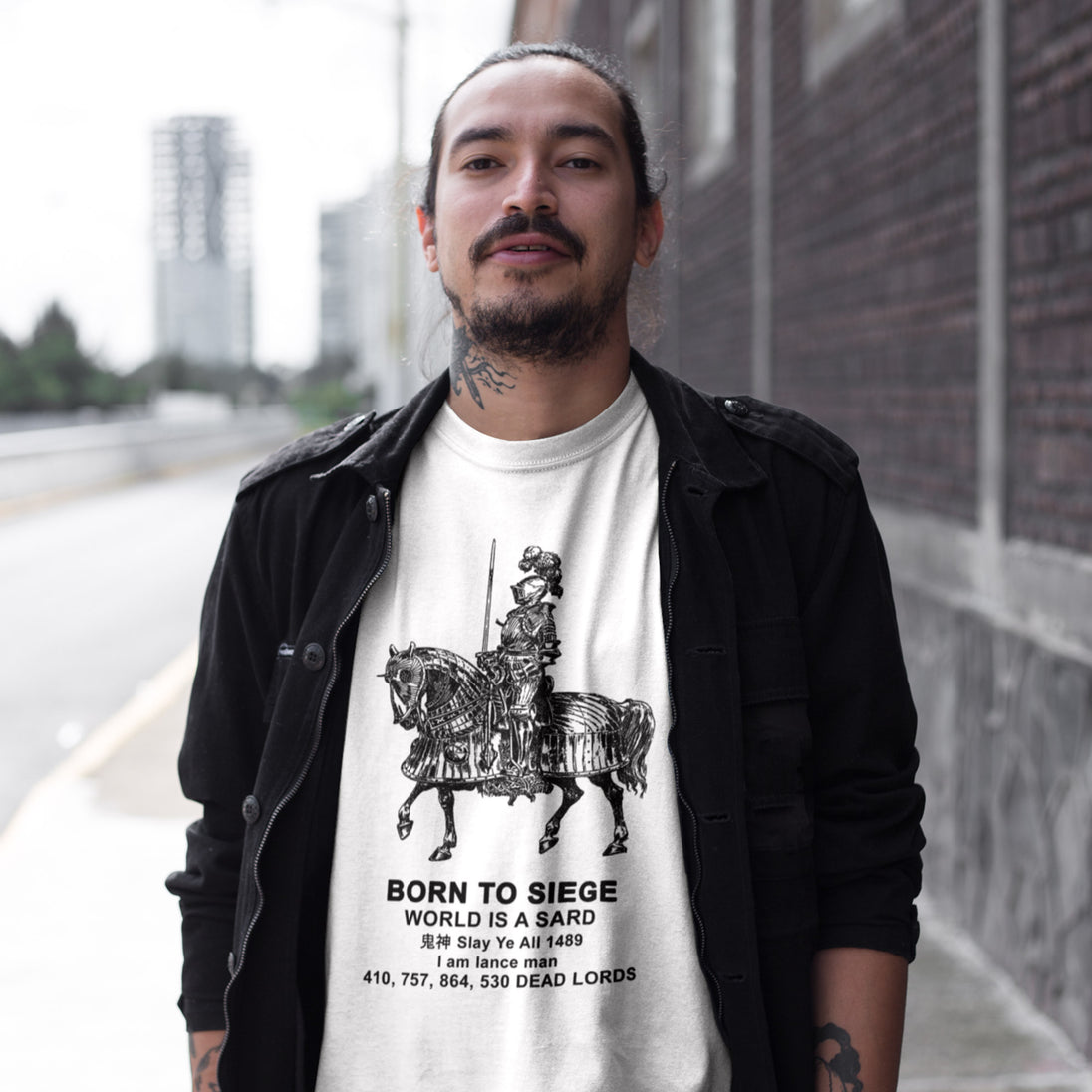 Tattooed man wearing white Born to Siege T-Shirt