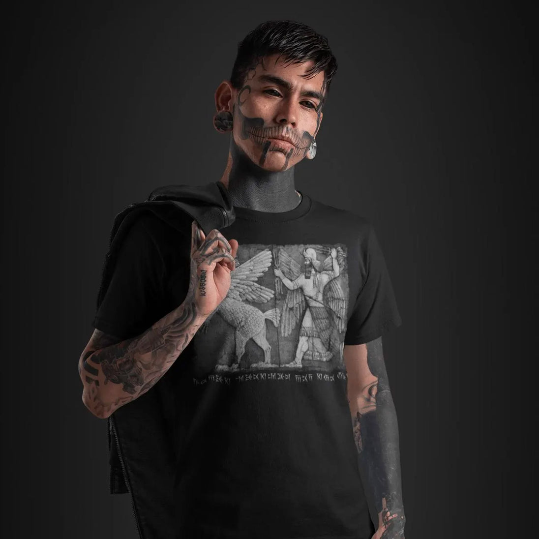 Tattoed man wearing Chaos Monster and Sun God T-Shirt

