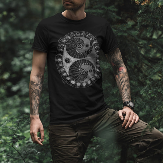 Person wearing a blackMoon Phases T-Shirt with a intricate design in a forest setting
