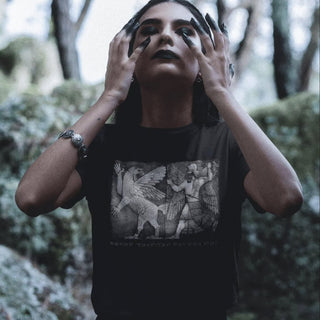 Person wearing a Chaos Monster and Sun God T-Shirt in a forest setting
