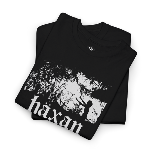 Black t-shirt with a white silhouette of a tree and a person on the front, and the text 'HäXAN WITCHCRAFT THROUGH THE AGES' below it.