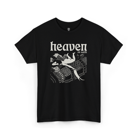 Black T-shirt with a graphic print of a woman playing with a cat in bed with 'HEAVEN ON EARTH' text above it.