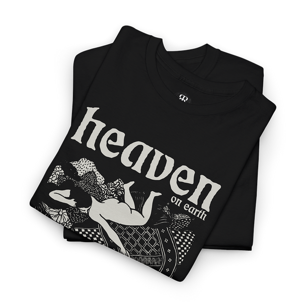 Black T-shirt with a graphic print of a woman playing with a cat in bed with 'HEAVEN ON EARTH' text above it.