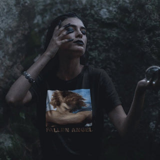 Person wearing a t-shirt with 'Fallen Angel' design against a dark background
