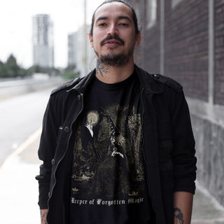 Man wearing a black t-shirt with a graphic design and text 'Keeper of Forgotten Magic'.