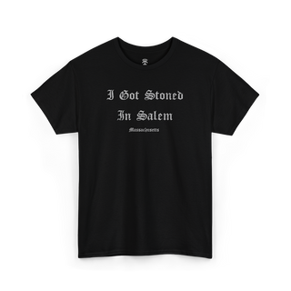 A black T-shirt with the text 'I GOT STONED IN SALEM' printed in white capital letters.