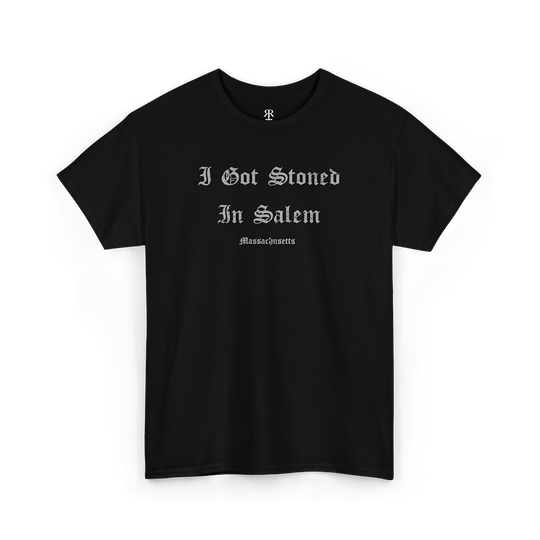 A black T-shirt with the text 'I GOT STONED IN SALEM' printed in white capital letters.