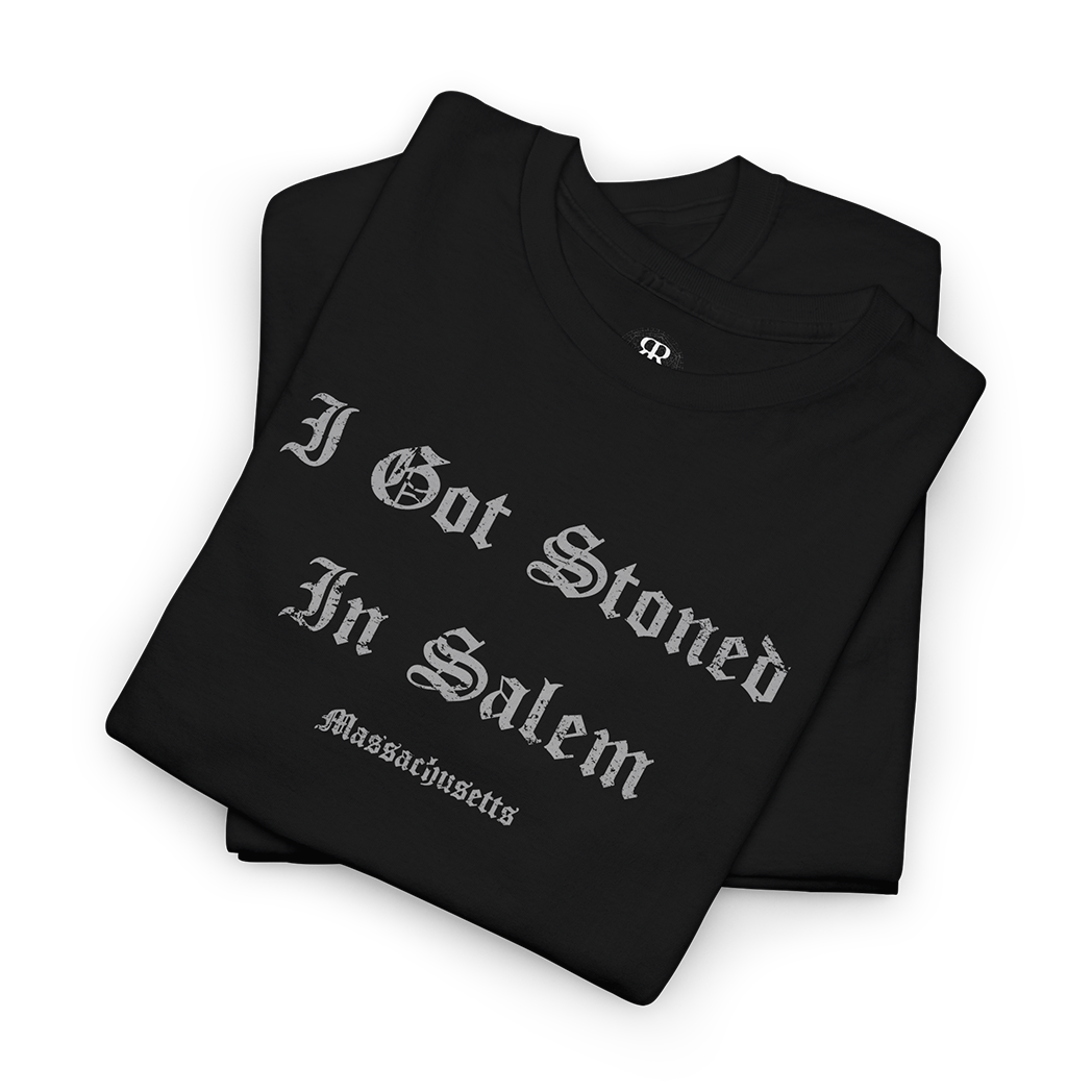 A black T-shirt with the text 'I GOT STONED IN SALEM' printed in white capital letters.