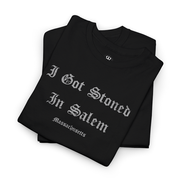A black T-shirt with the text 'I GOT STONED IN SALEM' printed in white capital letters.