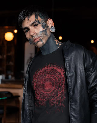 Man with tattoos wearing a black jacket and black t-shirt with red The Empyrean design by Gustave Dore.
