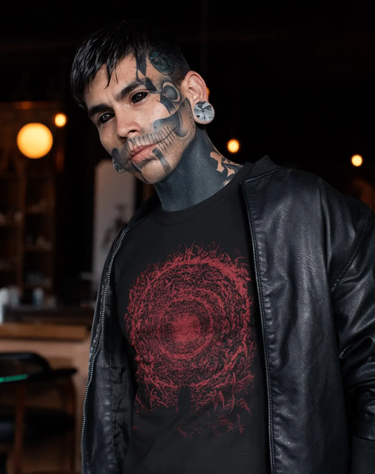 Man with tattoos wearing a black jacket and black t-shirt with red The Empyrean design by Gustave Dore.