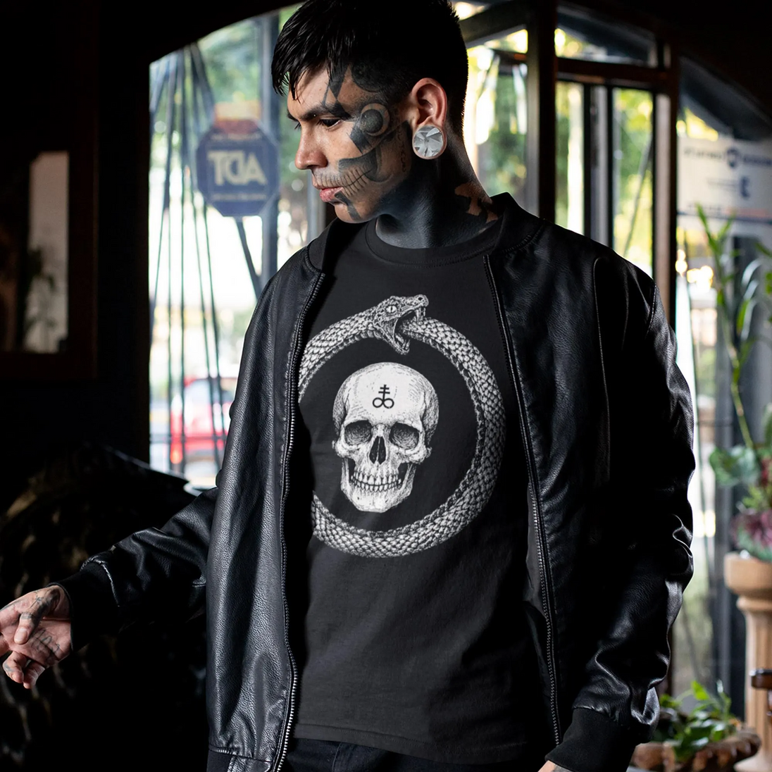 Tattooed man wearing Ouroboros Skull T-Shirt