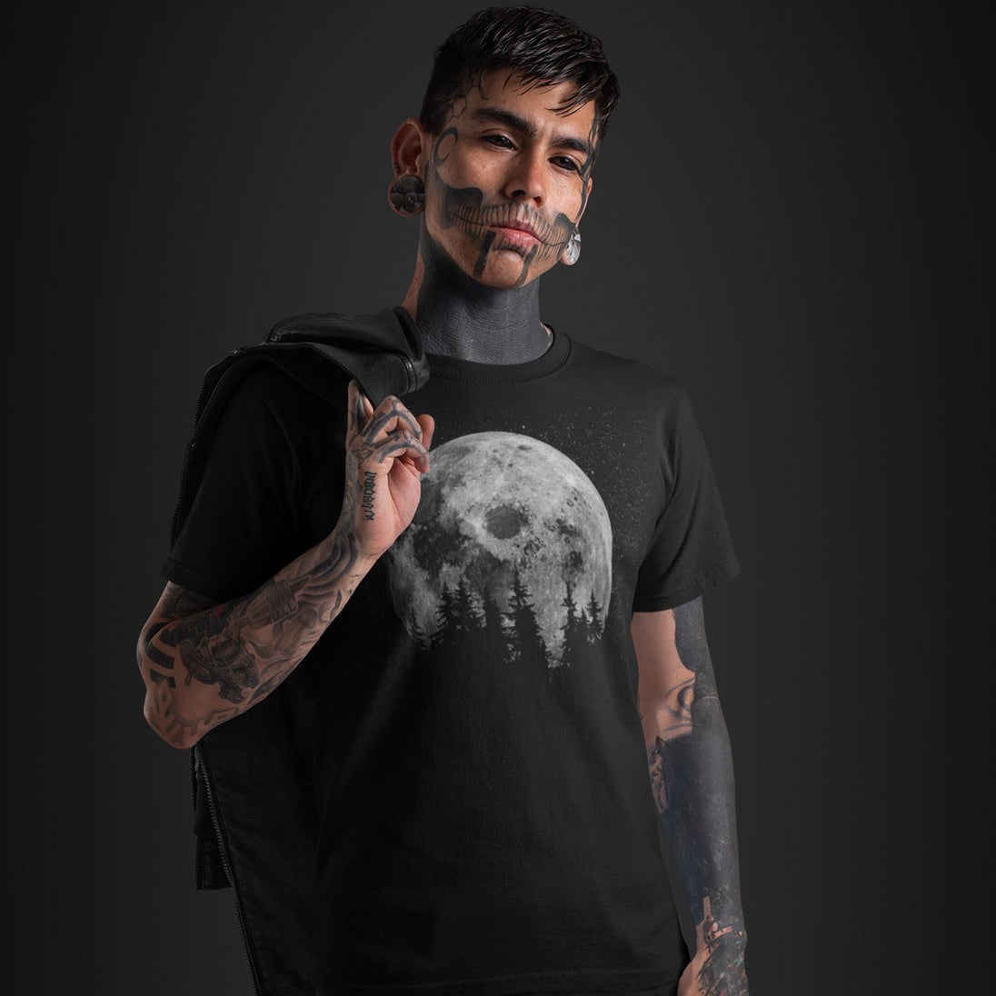 Person wearing a black t-shirt with a moon graphic on a dark background