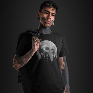 Person wearing a black t-shirt with a moon graphic on a dark background