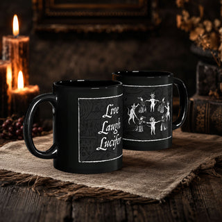 Two black ceramic mugs with white printed designs, displayed on a rustic burlap cloth with candles and a dark wooden table in the background.