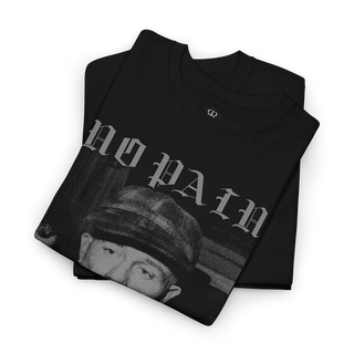 A folded black t-shirt with a grayscale graphic print featuring the text 'NO PAIN' and a face wearing a cap, displayed on a clean white background.