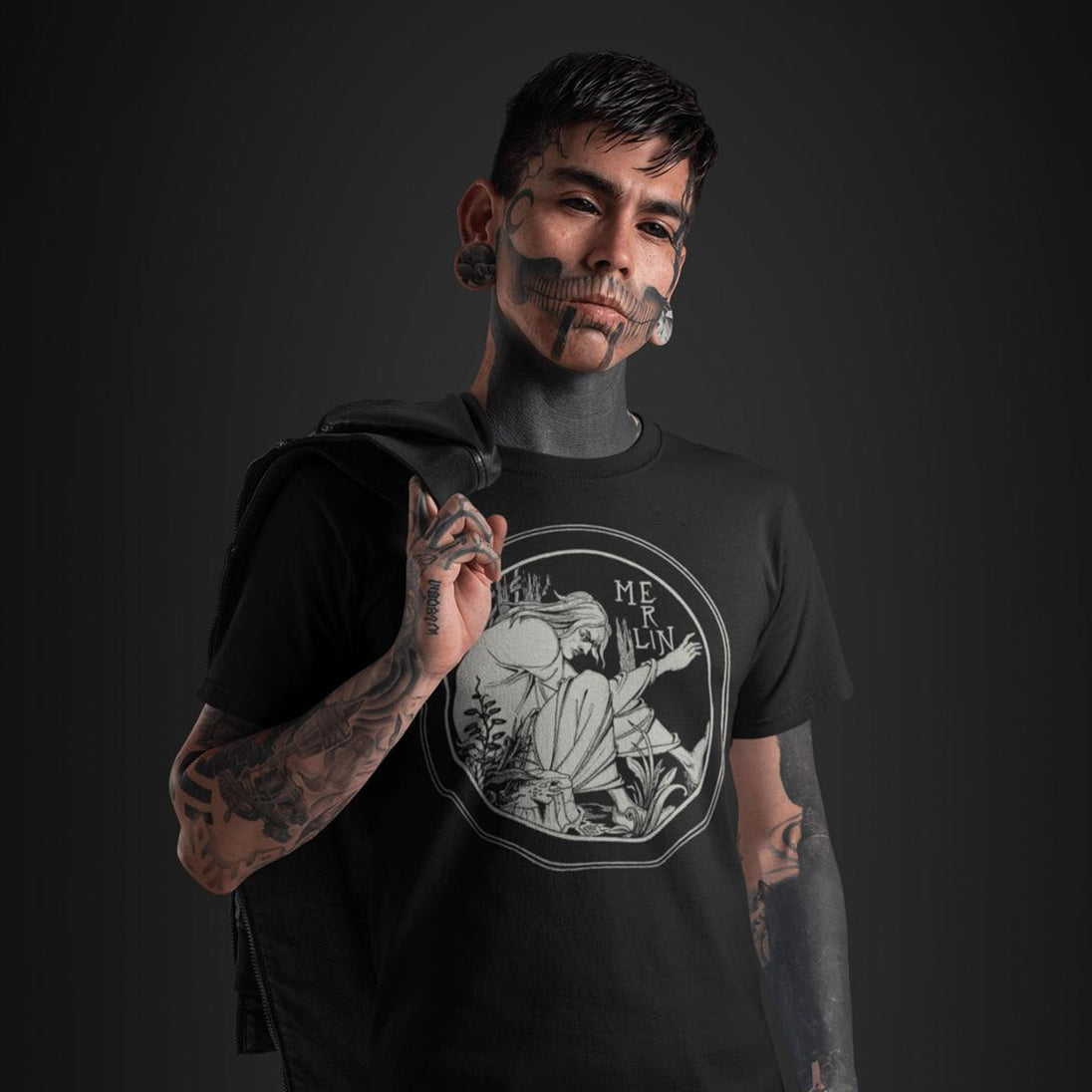 Tattooed man wearing Merlin T-Shirt
