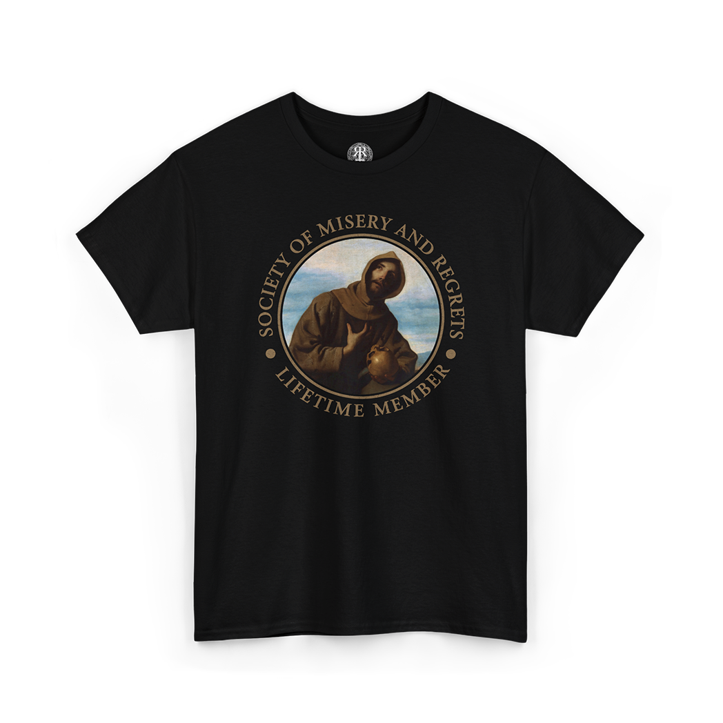 A black short-sleeve crewneck t-shirt featuring a circular graphic print of Saint Francis of Assisi with a rabbit, surrounded by the text 'SOCIETY OF MISERY AND REGRETS' and 'LIFETIME MEMBER' in a gold tone.