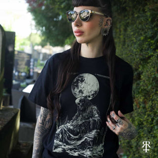 Woman wearing shirt showing full moon and skeletal figure