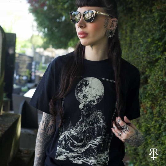 Woman wearing shirt showing full moon and skeletal figure