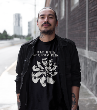 Alternative man wearing black t-shirt with a graphic saying ALL HAIL THE RAT KING