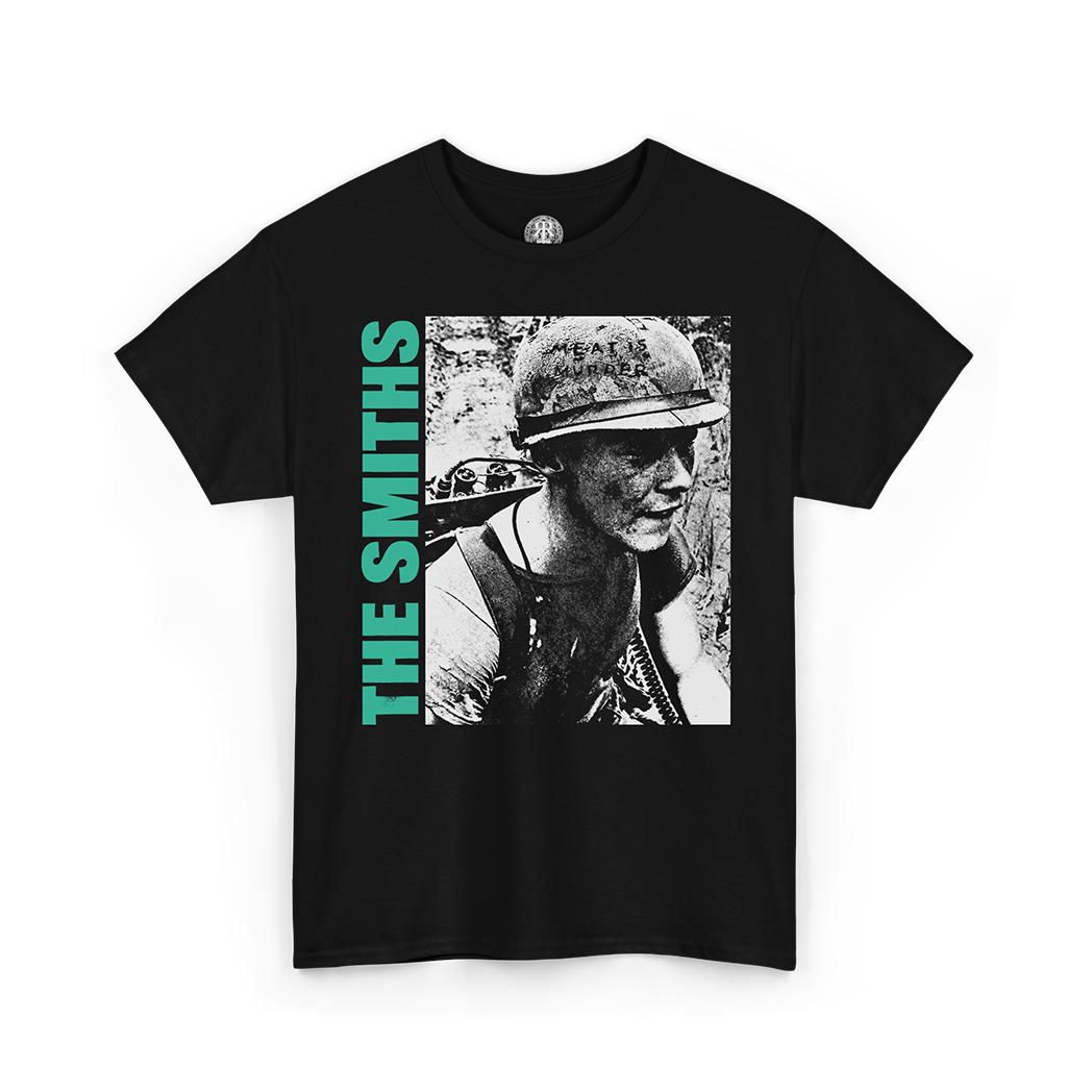 A black short-sleeve graphic t-shirt featuring a black-and-white photo print of a soldier wearing a helmet, with the text 'THE SMITHS' printed vertically in bright green on the left side of the graphic.