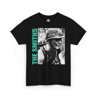 A black short-sleeve graphic t-shirt featuring a black-and-white photo print of a soldier wearing a helmet, with the text 'THE SMITHS' printed vertically in bright green on the left side of the graphic.