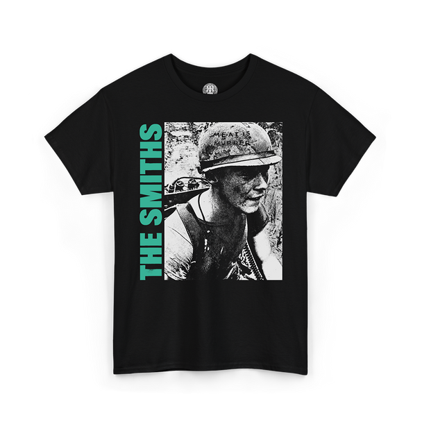 A black short-sleeve graphic t-shirt featuring a black-and-white photo print of a soldier wearing a helmet, with the text 'THE SMITHS' printed vertically in bright green on the left side of the graphic.