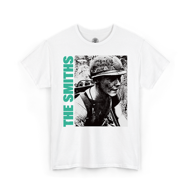 A white short-sleeve crewneck t-shirt featuring a graphic print of a black-and-white portrait of a soldier wearing a helmet, with the text 'THE SMITHS' printed vertically in bright green on the left side of the graphic.
