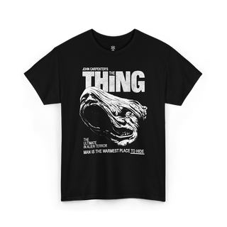 Black t-shirt with 'The Thing' graphic and text 'Man is the Warmest Place to Hide'.