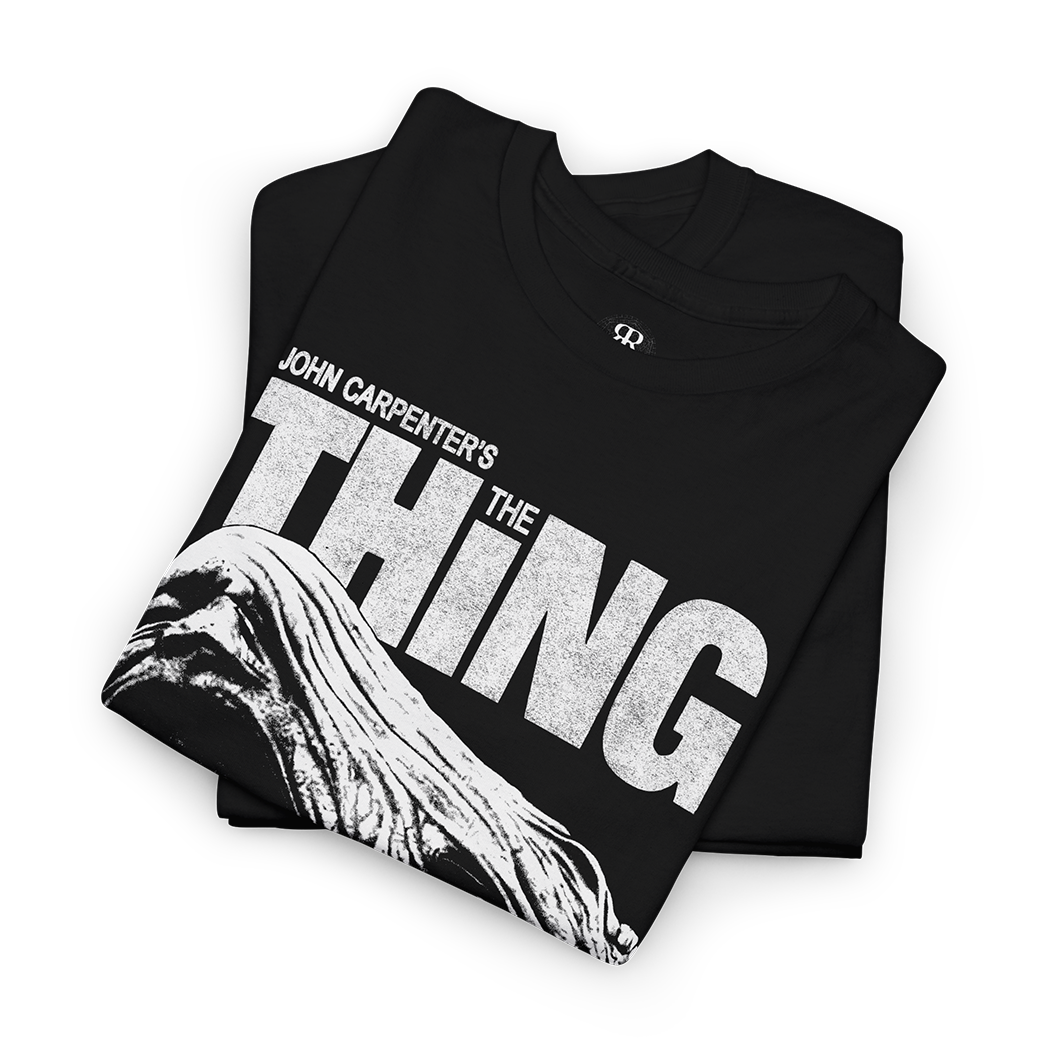 Black t-shirt with 'The Thing' graphic and text 'Man is the Warmest Place to Hide'.