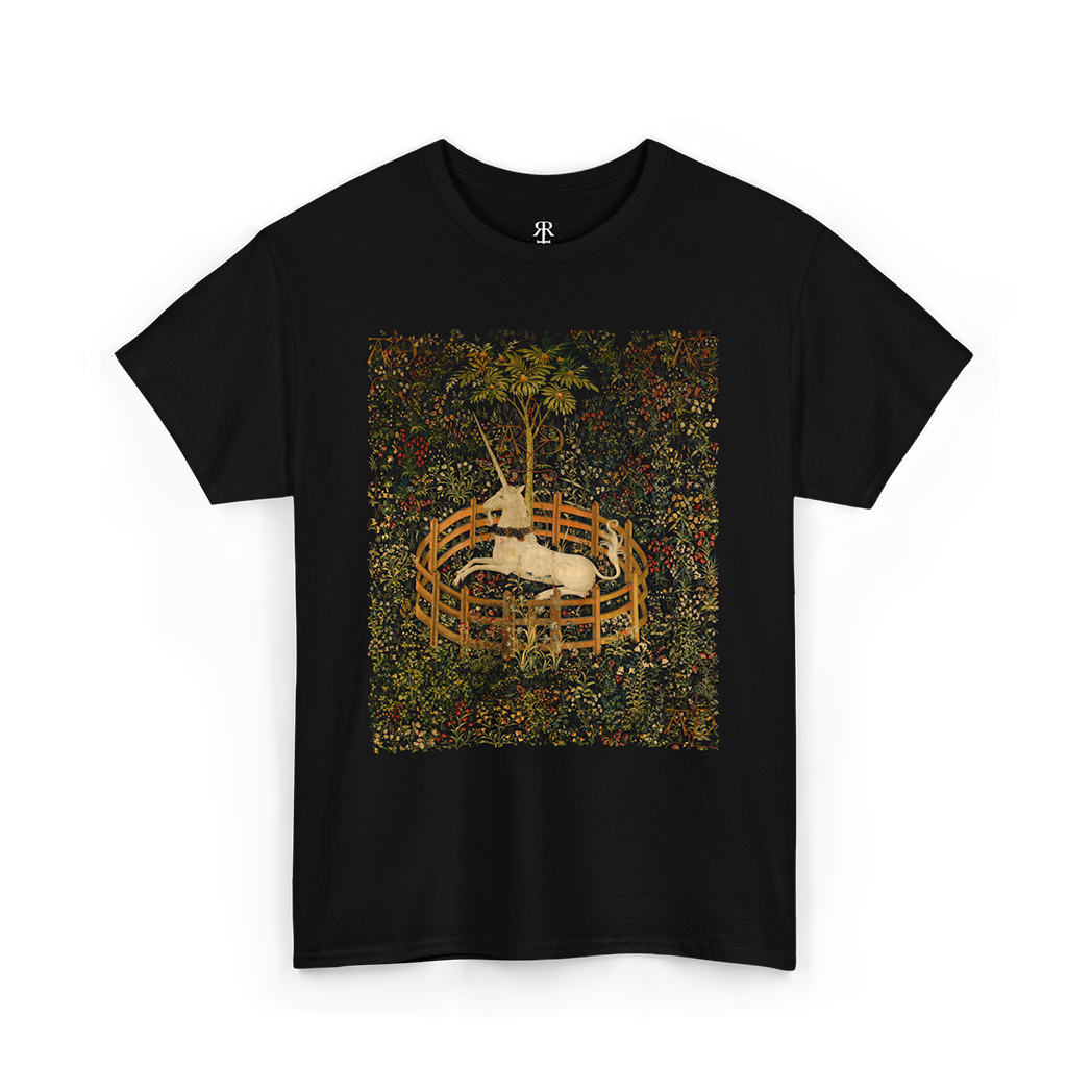 Black t-shirt featuring a central vintage illustration of a unicorn in a garden, surrounded by floral and fantastical elements reminiscent of medieval tapestries.