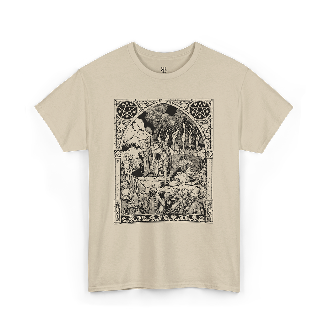 This image displays a beige t-shirt featuring a detailed and artistic print centered around the themes of witches and demons. 